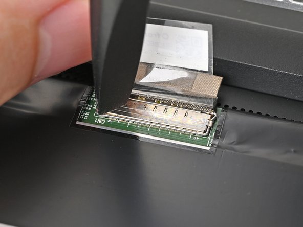 Push the metal locking tab down over the eDP cable connector until it snaps into place.