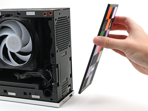 Lay the bottom of the Front Panel on the small, protruding lip in the silver base to align its tabs.