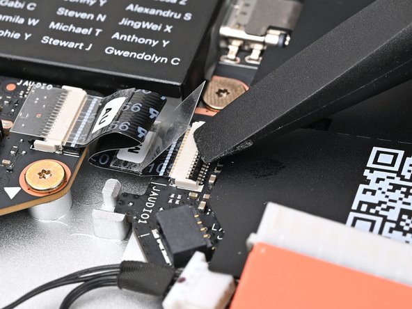 Use the flat end of your Framework Screwdriver, or a clean fingernail, to press down the locking tab on the Audio Board ZIF connector.