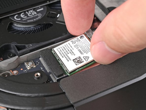 Grip the end of the Wi-Fi module with the screw hole and slide it out of its socket.
