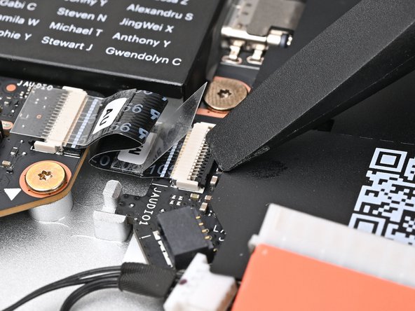 Use the flat end of your Framework Screwdriver, or a clean fingernail, to press down the locking tab on the Audio Board ZIF connector.