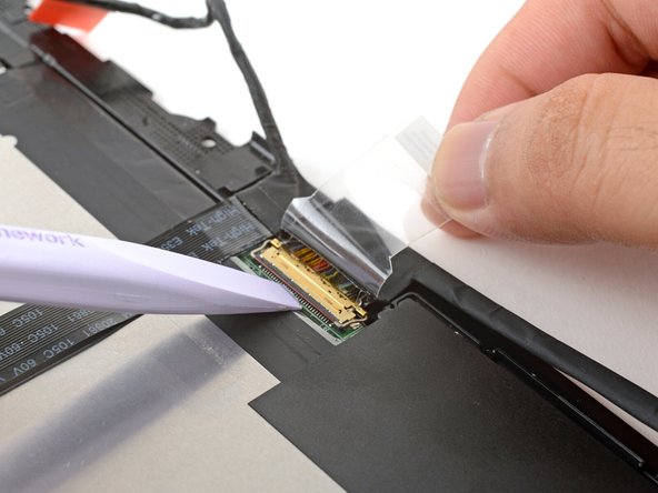 Use the flat end of your Framework Screwdriver to flip up the locking bar around the display connector.