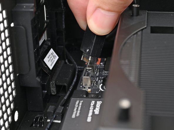 Slide the bottom Expansion Card cable into its socket on the Mainboard.