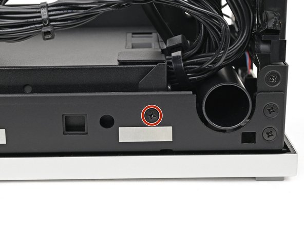 Use your Framework Desktop Screwdriver to remove the 4.0 mm‑long Phillips screw securing the power supply.