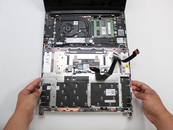 Gently place the Input Cover keyboard side down on the Bottom Cover as indicated on the image.  The cover should be about an inch and a half away from the bottom of the Mainboard so that you can comfortably install the Touchpad Cable.