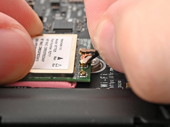 Press and hold the Wi-Fi module down with your fingers.