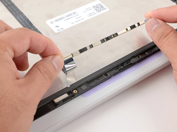 Avoid touching the black camera module near the center of the webcam.