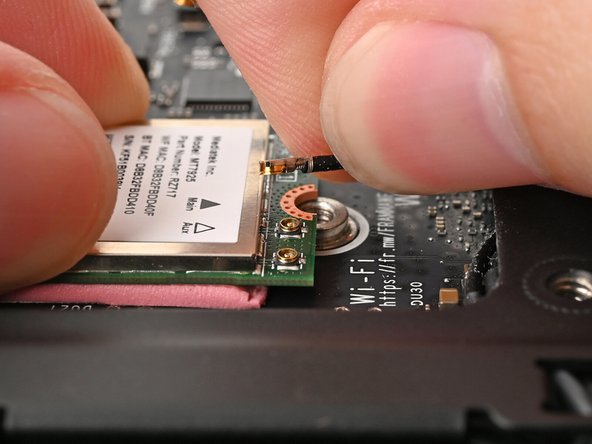 Use your fingers to grip the white antenna cable, as close to the metal head as possible.