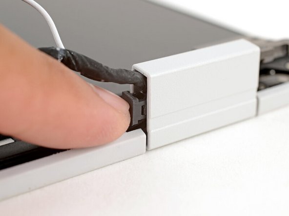 Use your fingers to press the clip into the hinge to secure the cables.