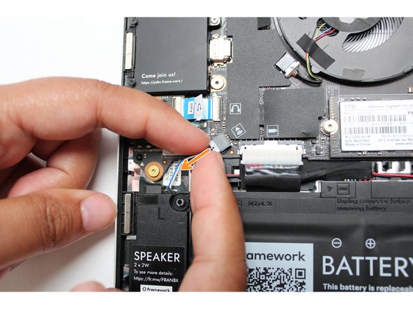 Using both fingers and a slight amount of force, disconnect the Speaker cable from the Mainboard by pulling it straight out.