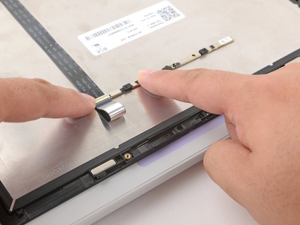 Flip the webcam over and gently hold it down with your fingers.