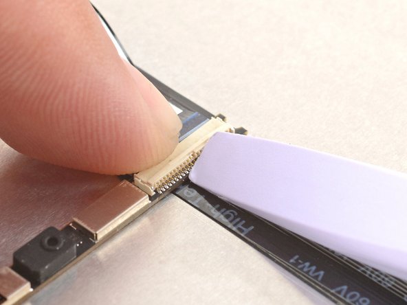 Use the flat end of your Framework Screwdriver or a fingernail to gently pry up the locking tab on the webcam cable ZIF connector.