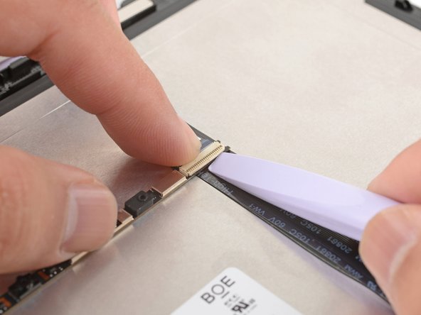 Use the flat end of your Framework Screwdriver or a fingernail to gently pry up the locking tab on the webcam cable ZIF connector.