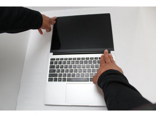 Align the corners of the Bezel to the display and place it down. The Bezel is attached by magnets and should easily click into place.