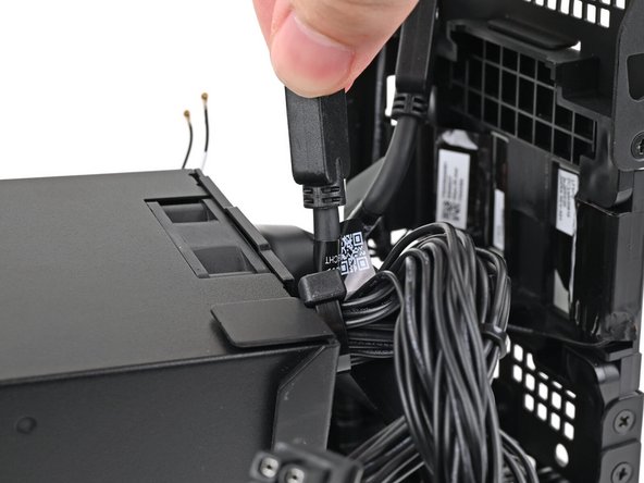 Push the right Expansion Card cable through the gap between the power supply and its duct.