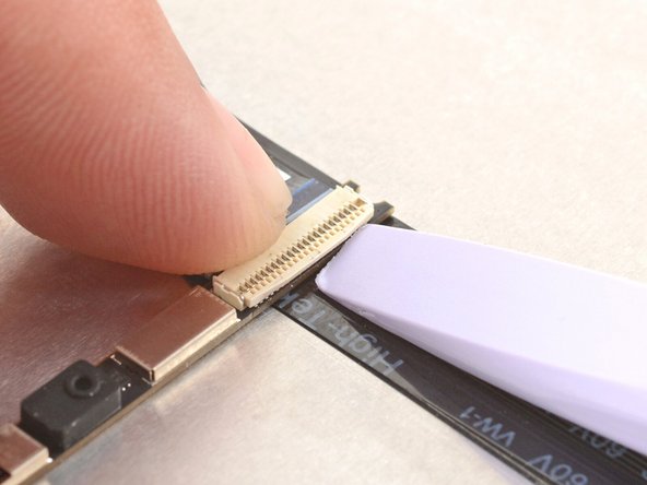 Use the flat end of your Framework Screwdriver or a fingernail to gently pry up the locking tab on the webcam cable ZIF connector.