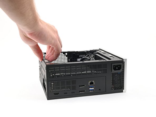 Lay the Desktop on its right side so its exposed internals are facing upward.