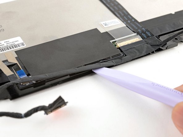 Slide the flat edge of your Framework Screwdriver under the length of the display cable to separate it from the display.