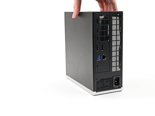 Lay the Desktop on its right side so its exposed internals are facing upward.