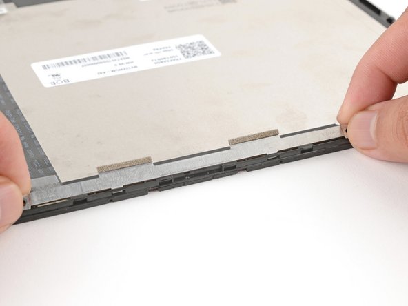 Make sure the tabs on the top edge of the webcam bracket sit in their slots on the top edge of the display.