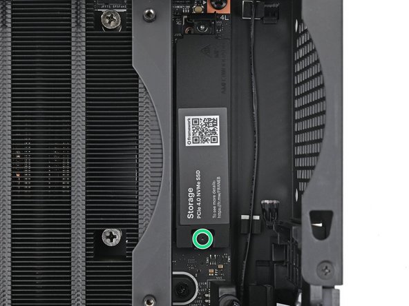 Use your Framework Desktop Screwdriver to loosen the captive screw T5 Torx securing the primary storage heat spreader.