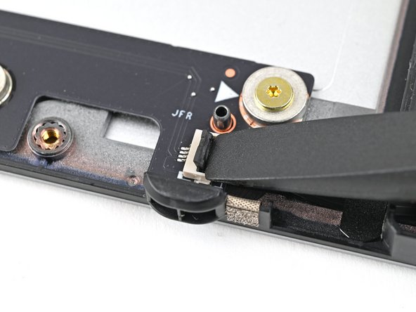 Use your fingers to grip the brown pull tab and slide the fan cable straight out of its socket.