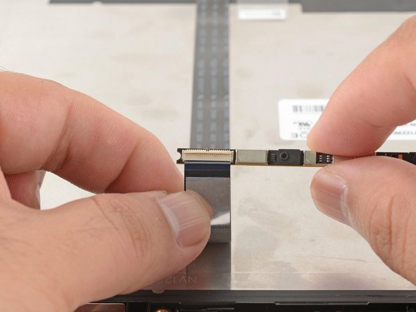 Slide the webcam cable out of its connector.