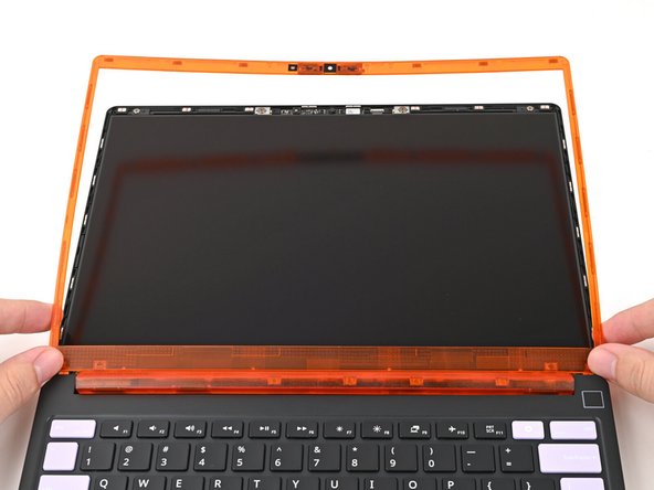 If there's any liners covering adhesive on the back of the Bezel, remove them now.