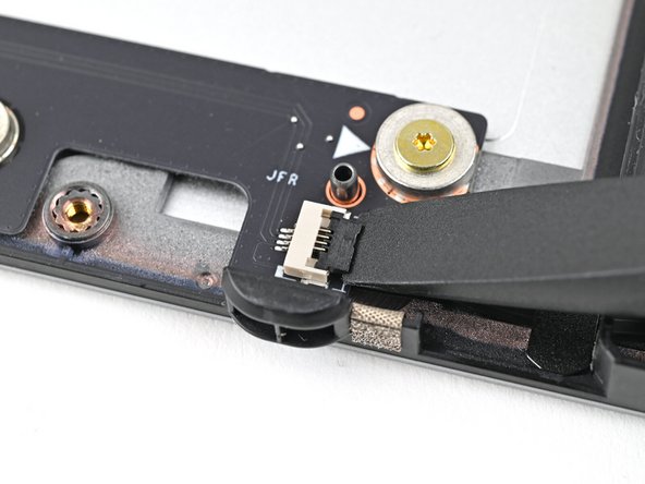 Use the flat end of your Framework Screwdriver, or a clean fingernail, to lift up and release the locking tab on the right fan ZIF connector.