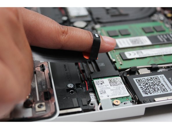 Using slight force, connect the Touchpad Cable by aligning it to the socket on Mainboard.  You should hear it click into place once properly connected.