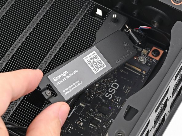 Lift the primary storage heat spreader out of the Desktop and remove it.