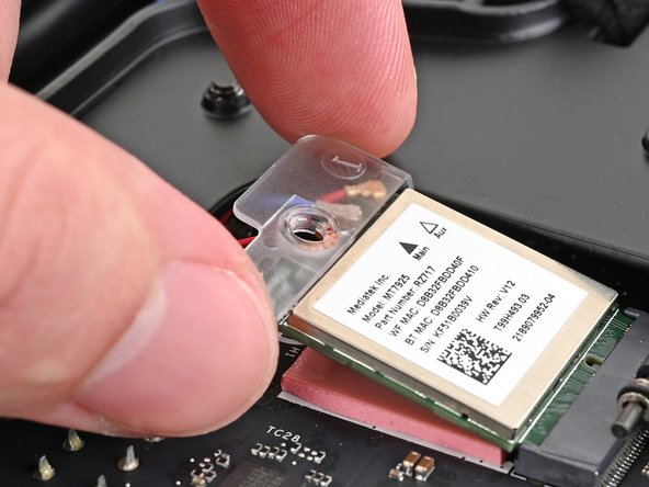 Rotate the bracket over the Wi-Fi module, making sure the screw hole isn't being obstructed by the antenna cables.