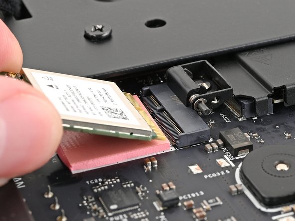 Hold the Wi-Fi module by its edges. Don't touch the gold contacts with your fingers. If you do, wipe the contacts with a clean, lint-free cloth to remove any finger oils.