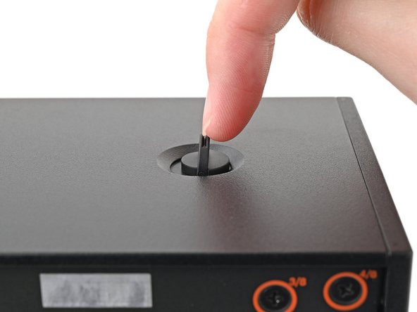 Use your finger to lift up the two D-rings on the Top Panel screws.