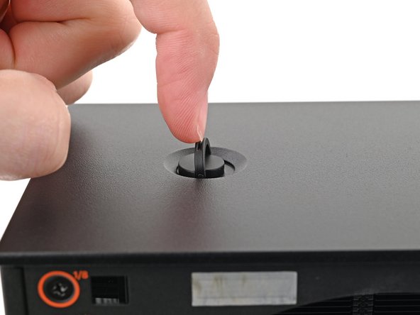 Use your finger to lift up the two D-rings on the Top Panel screws.