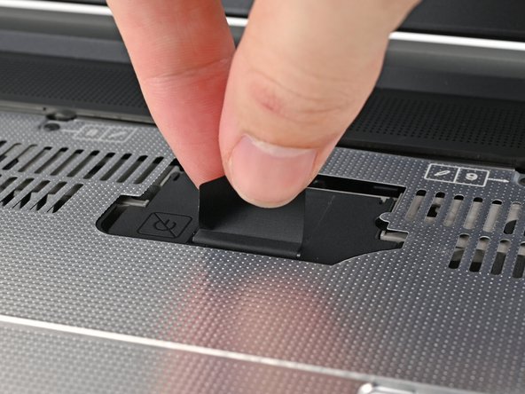 Flip over the laptop and open it.