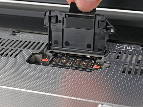 Lift the interposer door by its black pull tab and let it rest upright.