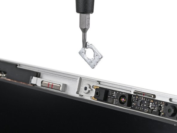 Use the magnetic tip of your Framework Screwdriver to pull the two washers off the Top Cover.