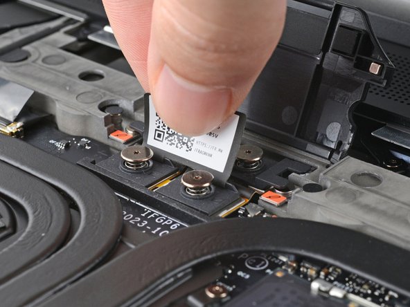 Depending on if you're installing a Graphics Module or the Expansion Bay Shell, the interposer should be oriented so either rubber grommets or metal tabs cover the Expansion Bay screws.