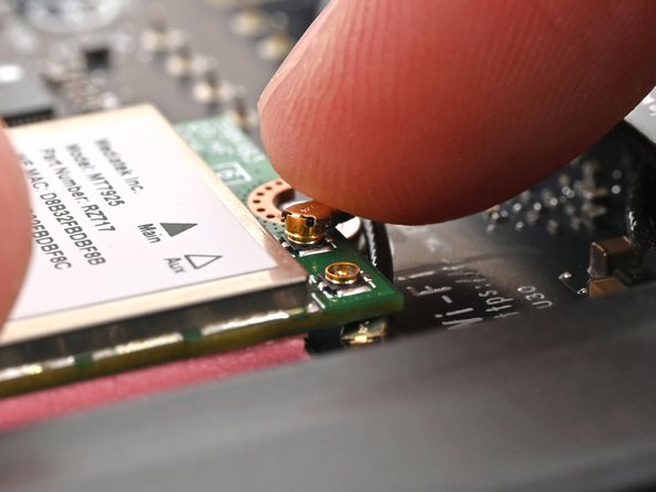 Hold the Wi-Fi module down with your fingers.