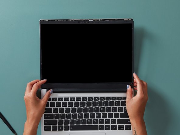 Align the corners of the Bezel to the display and place it down. The Bezel is attached by magnets and should easily click into place.