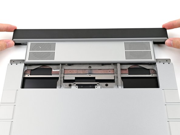 While keeping the module level with the laptop, slide it into its slot.
