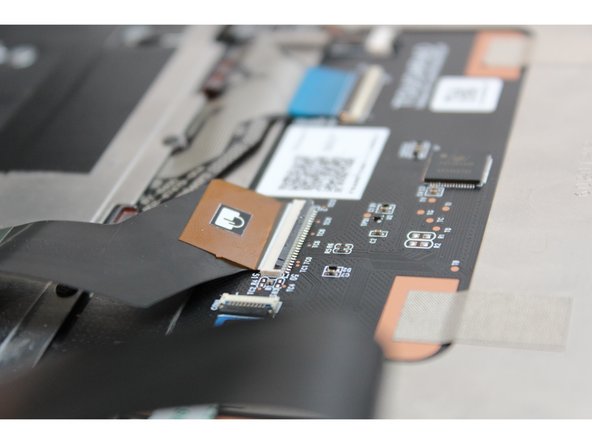 Grip the brown tab and slide the cable straight out.