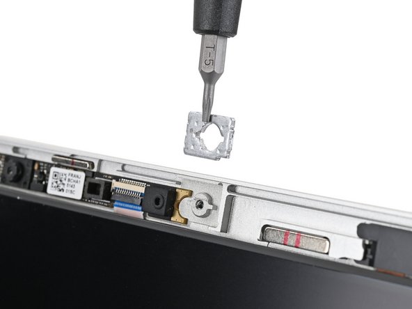 Use the magnetic tip of your Framework Screwdriver to pull the two washers off the Top Cover.