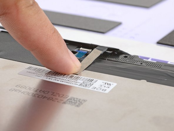 Use your finger to press the display cable grounding tape onto the metal back of the display.