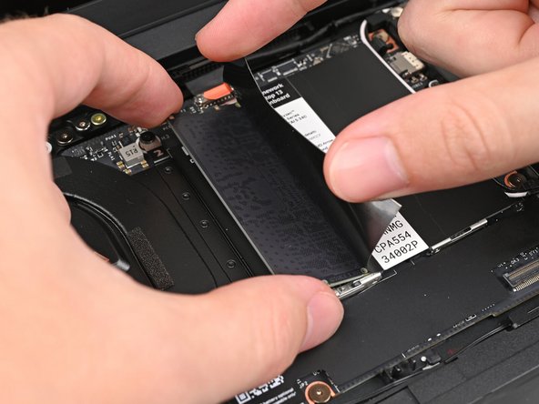 Slide the memory module out of its socket and remove it.