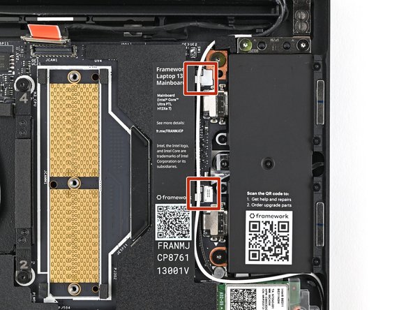 Use the flat end of your Framework Screwdriver to press the two Antenna Cables into their clips on the Mainboard.