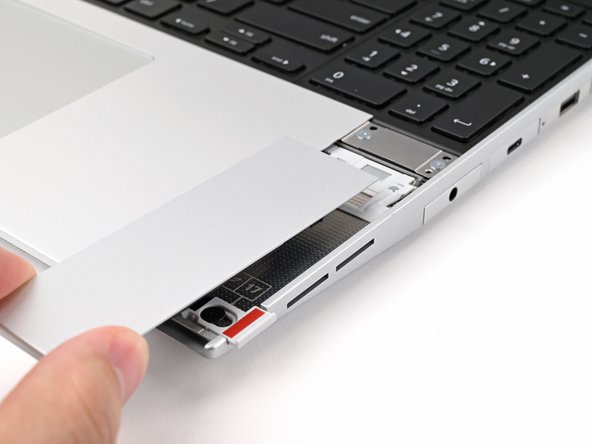 Place the Touchpad Spacer over its spot on the laptop with the bottom edge overhanging slightly.