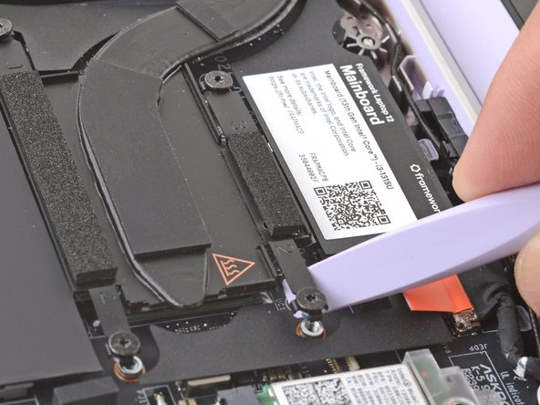 Twist the Framework Screwdriver to lift the Heatsink arm and loosen the Heatsink.