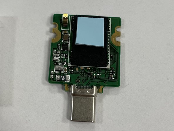 Remove the protective plastic from both sides of the thermal pad.  Stick it to the top half of the flash package as shown in the image.